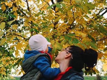 Low angle view of woman standing on tree