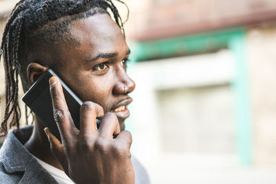 Portrait of young man using mobile phone