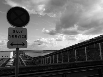 Low angle view of road sign against sky