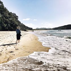 Rear view of man standing on beach