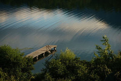 High angle view of trees by lake against sky