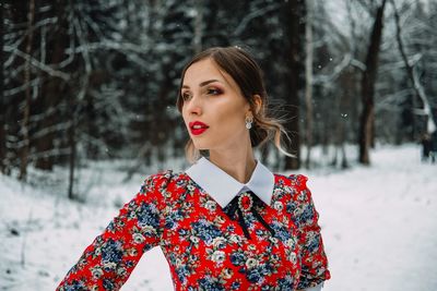 Young woman standing in snow