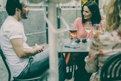 Friends sitting at outdoor restaurant