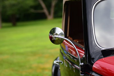 Close-up of side-view mirror in vintage car