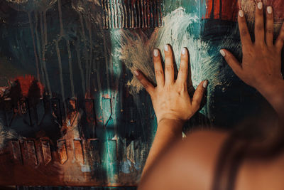 Hands of a painter on canvas