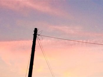Low angle view of electricity pylon against sky