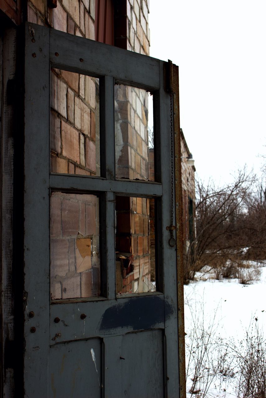 built structure, architecture, building exterior, wood - material, old, house, abandoned, weathered, obsolete, window, run-down, damaged, wooden, door, day, deterioration, clear sky, sky, closed, outdoors