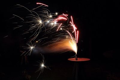 Low angle view of firework display at night