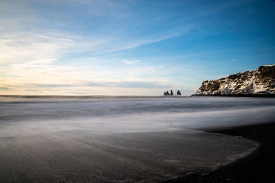 Scenic view of beach against sky during sunset