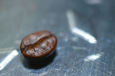 Close-up of roasted coffee bean on table