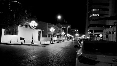 Cars on city street at night