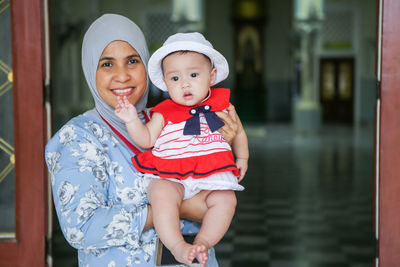 Portrait of a smiling muslim women and baby