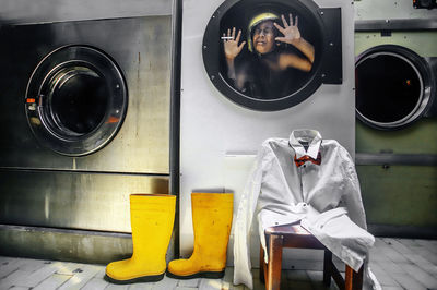 Shirtless boy crying trapped in washing machine