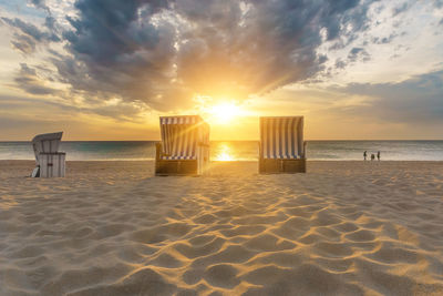 Scenic view of beach against sky during sunset