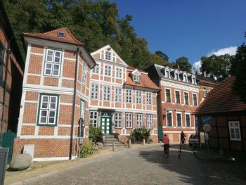 Residential buildings in town against sky