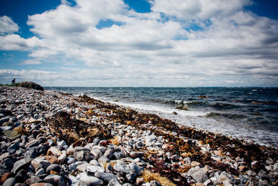 Scenic view of sea against cloudy sky