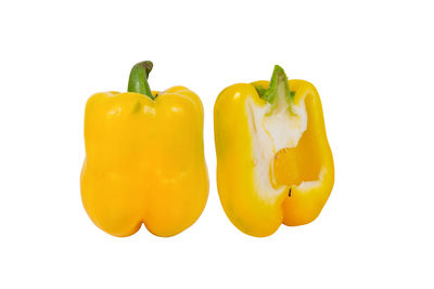 Close-up of yellow bell peppers against white background