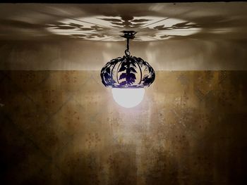 Illuminated chandelier hanging from ceiling
