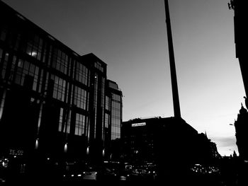 Low angle view of silhouette buildings against sky at dusk