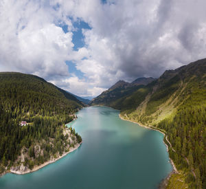 Scenic view of lake amidst mountains against sky