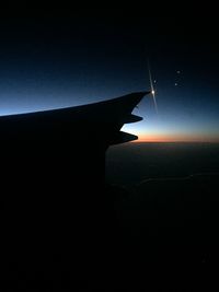 Cropped image of airplane flying over sea