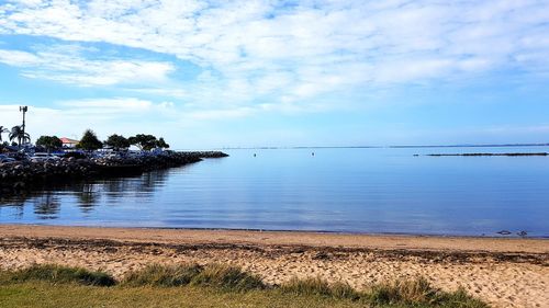 Scenic view of sea against blue sky