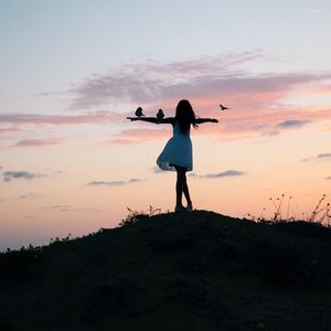 Rear view of woman standing on beach