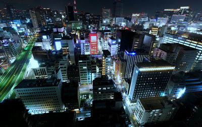 High angle view of illuminated buildings in city at night