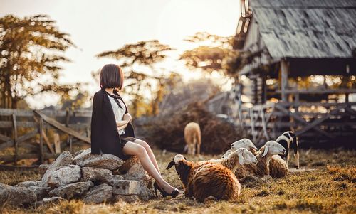 Woman with umbrella on land