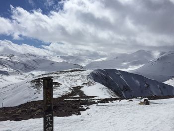 Scenic view of snow covered mountains against sky