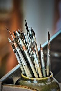 Close-up of paintbrushes in container