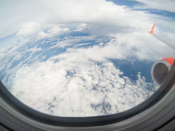 Cloudy sky seen through airplane window