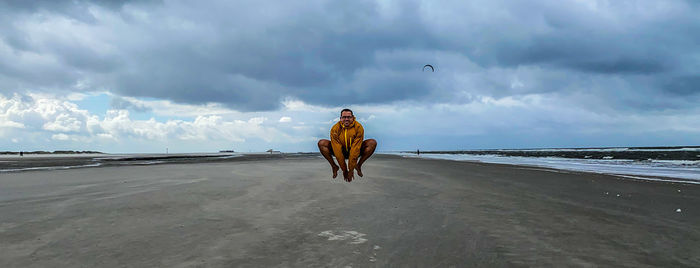 Woman on beach against sky