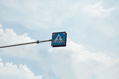 Low angle view of road sign against sky