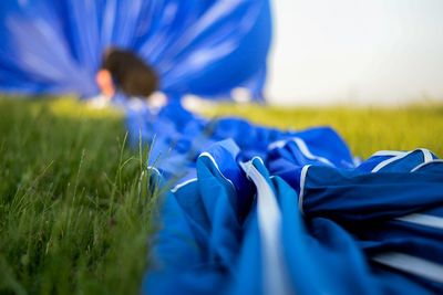 Blue canvas of hot air balloon on grassy field