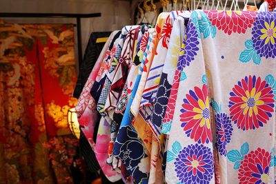 Multi colored clothes hanging for sale at market stall