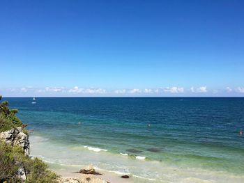 Scenic view of sea against blue sky