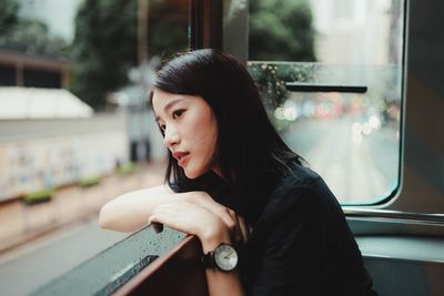 Portrait of beautiful young woman in train