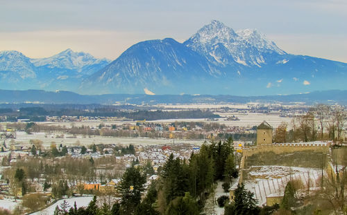 High angle view of townscape and mountains against sky