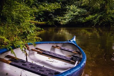 Boats moored in river