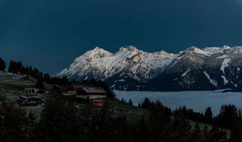 Scenic view of snowcapped mountains against clear sky