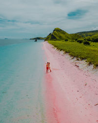 Couple on pink beach komodo islands