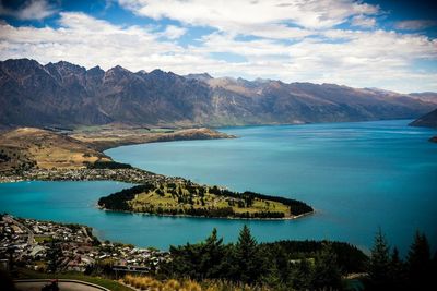 Scenic view of sea and mountains against sky