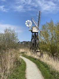 Traditional windmill on field against sky