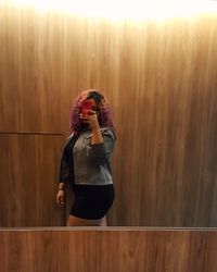 Full length of woman standing on wood