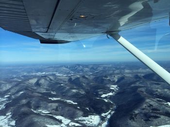 Cropped image of airplane flying over landscape