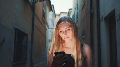 Young woman using smart phone outdoors