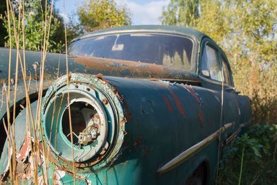 Abandoned car on field