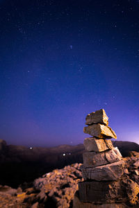 Rock formation against sky at night