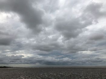 Scenic view of sea against storm clouds